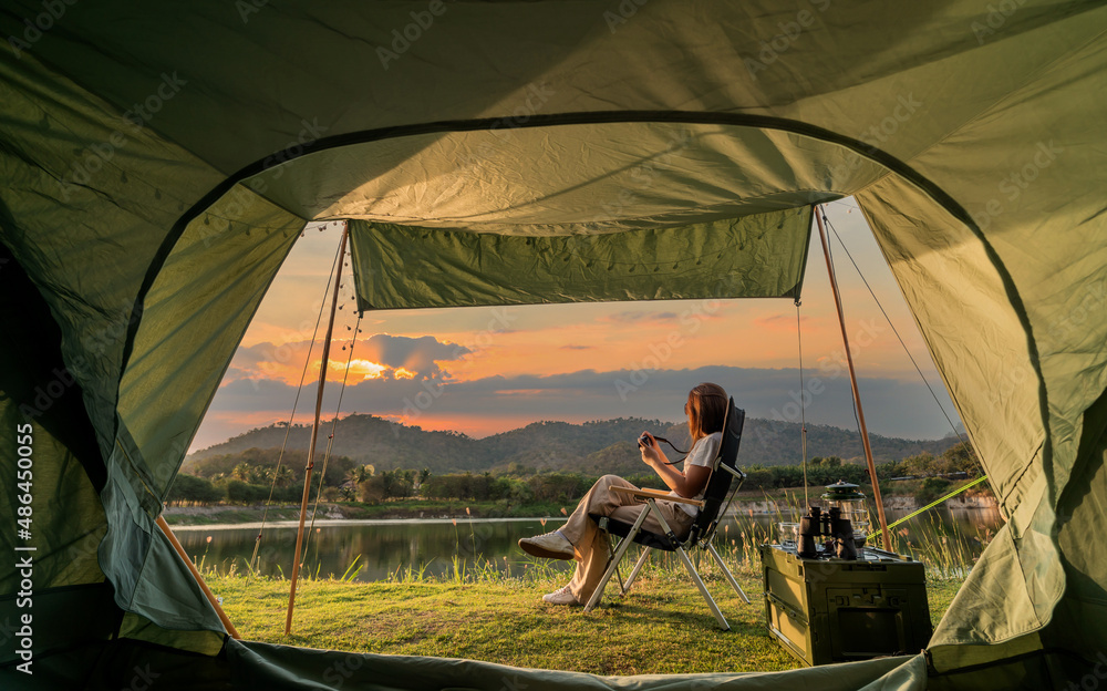 Asian woman travel and camping alone at natural park in Thailand. Recreation and journey outdoor activity lifestyle.